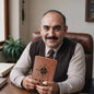 Man holding a leather journal travel for dad with compass design at wooden desk