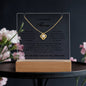 Gift for Mom Necklace Acrylic LED with gold chain and pendant displayed on clear acrylic stand