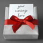 Gift Wrap with silver paper and red ribbon tied in a bow with a customizable message card