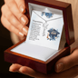 Graduation Cap Necklace with the name displayed in an open wooden gift box with a personalized message card