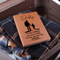 Leather accessory journal with Daddy quote, gift idea for a dad, placed on folded clothes in an open suitcase