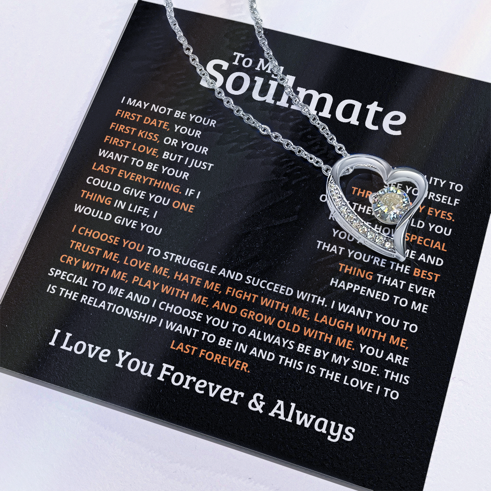 Silver heart-shaped necklace for gold with a small crystal pendant on a soulmate message card