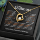 Gold heart-shaped necklace for gold with a central gemstone on a soulmate message card