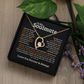 Gold heart pendant necklace for gold with a sparkling center stone on a romantic soulmate message card